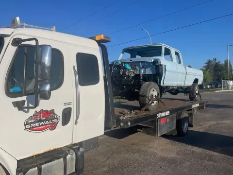 Tow truck assisting with accident vehicle recovery in Chestermere.