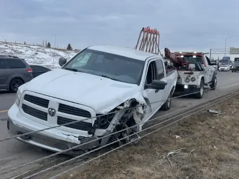 Accident towing service moving a damaged vehicle in Strathmore