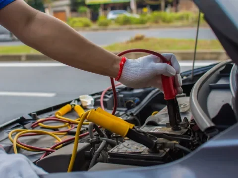 Battery boost service helping a vehicle start in Chestermere.