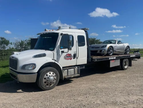 Tow truck moving a vehicle from a Calgary impound lot