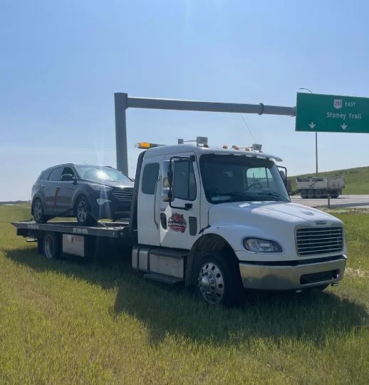 Tow truck providing car towing service for a driver in Chestermere, Alberta.
