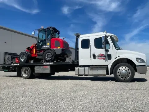 Tow truck operator speaking with a customer during a roadside service call