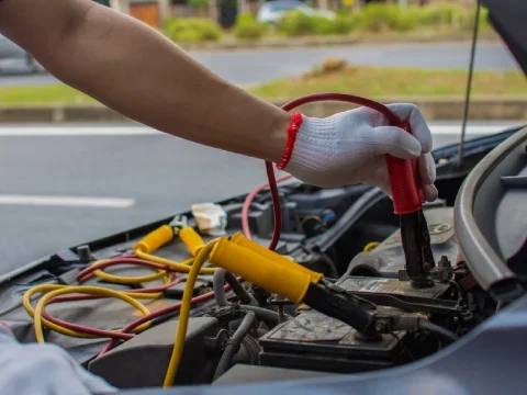 Technician providing a safe jump start for a vehicle in NW Calgary
