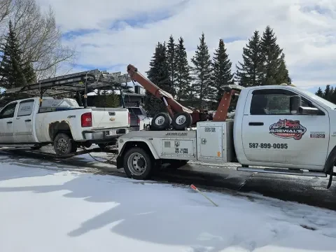 Vehicle recovery from a ditch in SE Calgary using careful winch-out support