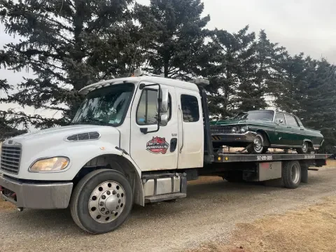 Tow truck providing roadside towing support on Highway 2A near Okotoks