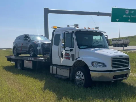 Tow truck service assisting a driver in Strathmore