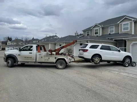 Tow truck assisting a vehicle near Centre Street in Langdon