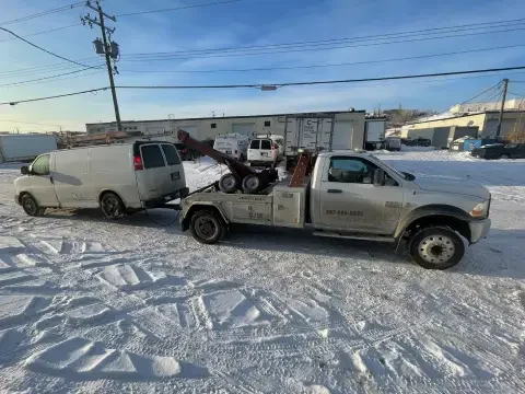 Recovery tow truck helping a damaged or stuck vehicle in Langdon