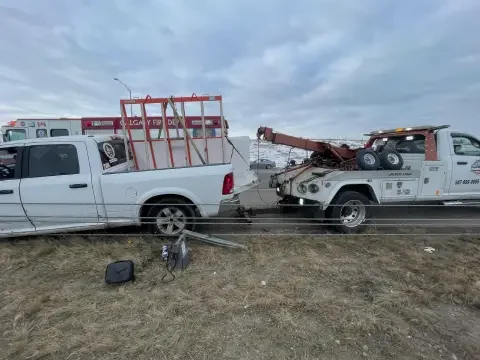 Tow truck providing winch-out service for a stuck vehicle in Langdon